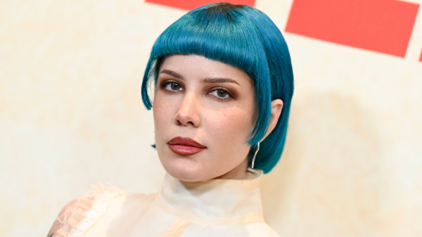 Halsey poses in a highneck offwhite sleeveless shirt and a turquoise bob hairstyle
